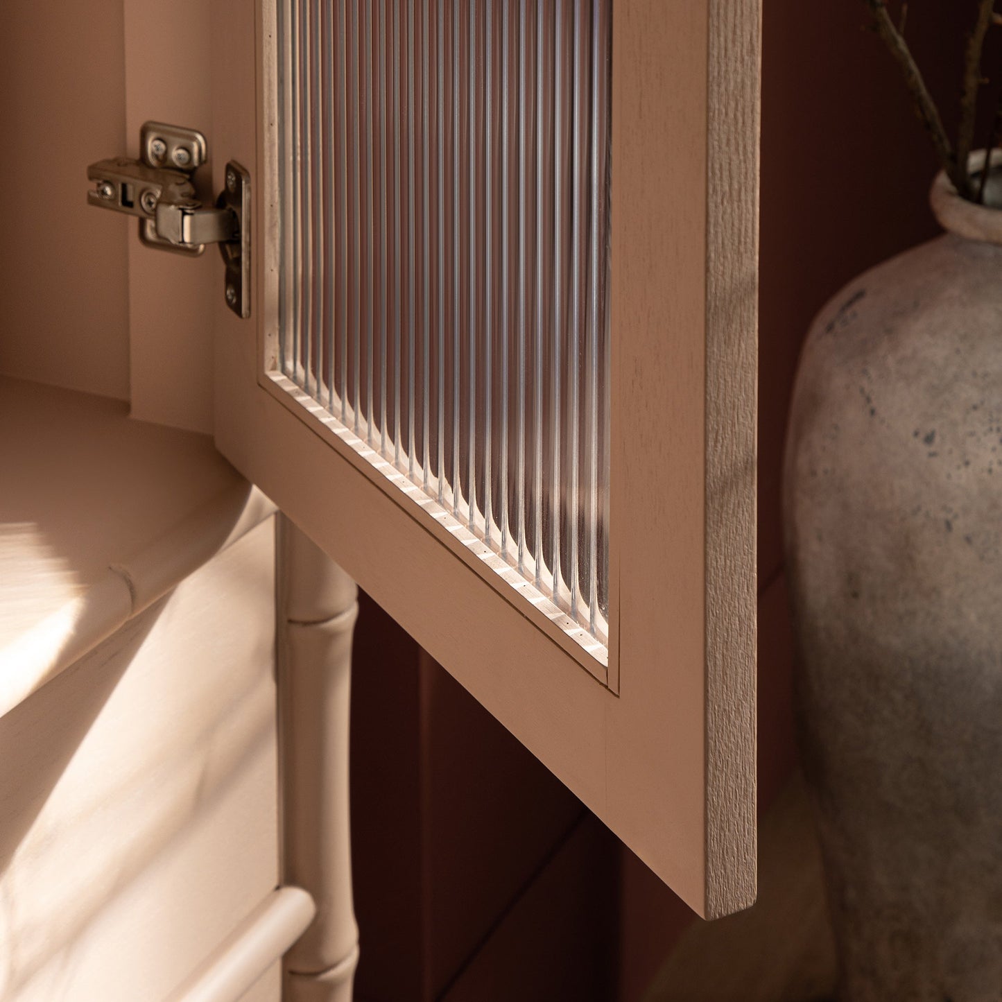 Elstowe Faux Bamboo and Fluted Glass 2-Door Cabinet, Nude Pink